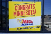 A sign outside Minnesota Lottery headquarters celebrates the state’s first Mega Millions jackpot winner.