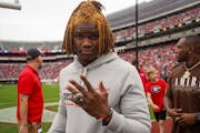 Safety Lewis Cine holds up his national championship ring at Georgia’s pro day this month. 