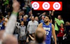 Minnesota Timberwolves center Karl-Anthony Towns looks at the cheering fans during Game 3 of an NBA basketball first-round playoff series against the 