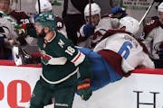 The Wild’s Jordan Greenway checked Colorado’s Erik Johnson into the Avalanche’s bench during the second period Friday. Greenway scored twice in 