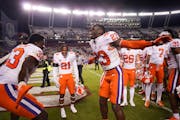 Cornerback Andrew Booth Jr. (23) celebrated with teammates after Clemson’s win over South Carolina in November,
