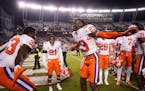 Cornerback Andrew Booth Jr. (23) celebrated with teammates after Clemson’s win over South Carolina in November,