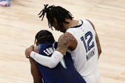 Grizzlies guard Ja Morant consoled Timberwolves guard Anthony Edwards late in the second half of Game 6 on Friday night.