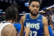 Ja Morant (12) of the Memphis Grizzlies and Karl Anthony-Towns (32) of the Minnesota Timberwolves greet each other at the end of game 6 of the playoff