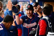 Kyle Garlick was greeted with high-fives in the Twins dugout after hitting a two-run homer in the sixth inning Saturday.
