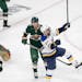 David Perron of the St. Louis Blues celebrated after getting the puck past Minnesota Wild goalie Marc Andre Fleury (29) for a goal in the third period
