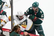Minnesota Wild left wing Matt Boldy (12) pushed Vegas Golden Knights center Jonathan Marchessault (81)into the boards in the first period. The Minneso