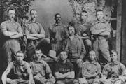 “Bud” Fowler, seen here at center, stood with his teammates in Keokuk, Iowa, where he played baseball in 1884 after leaving Stillwater.