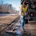 Street service worker Bradley Therres smoothed asphalt over a pothole on Shepard Road in 2019.