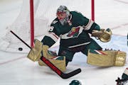 Minnesota Wild goalie Marc-Andre Fleury deflects a shot during the first period of the team's NHL hockey game against the Colorado Avalanche, Friday, 