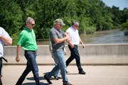 Gov. Tim Walz approached the flooded Cottonwood River in New Ulm with Sen. Amy Klobuchar on July 8, 2018. New Ulm is one municipality that needs help 