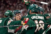 The Wild’s Joel Eriksson Ek (14) celebrated with linemates Marcus Foligno, left, and Jordan Greenway (18) after scoring in the first period in Game 