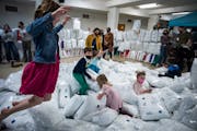 Children at Lake Harriet United Methodist Church in Minneapolis played in a pile of (plastic-wrapped) pillows, which will be donated to local homeless