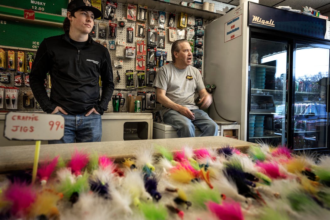 Parker Sonenstahl, left, and his dad, Tim Sonenstahl. owner of Wayzata Bait and Tackle, waited Tuesday for a customer.