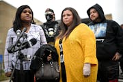 Katie Wright, center, stands beside activist Toshira Garraway and her son, Damik Bryant, during a news conference.