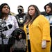 Katie Wright, center, stands beside activist Toshira Garraway and her son, Damik Bryant, during a news conference.