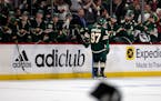 Wild winger Kirill Kaprizov (97) celebrated with teammates on the bench — and waited for hats to be removed from the Xcel Energy Center ice —after
