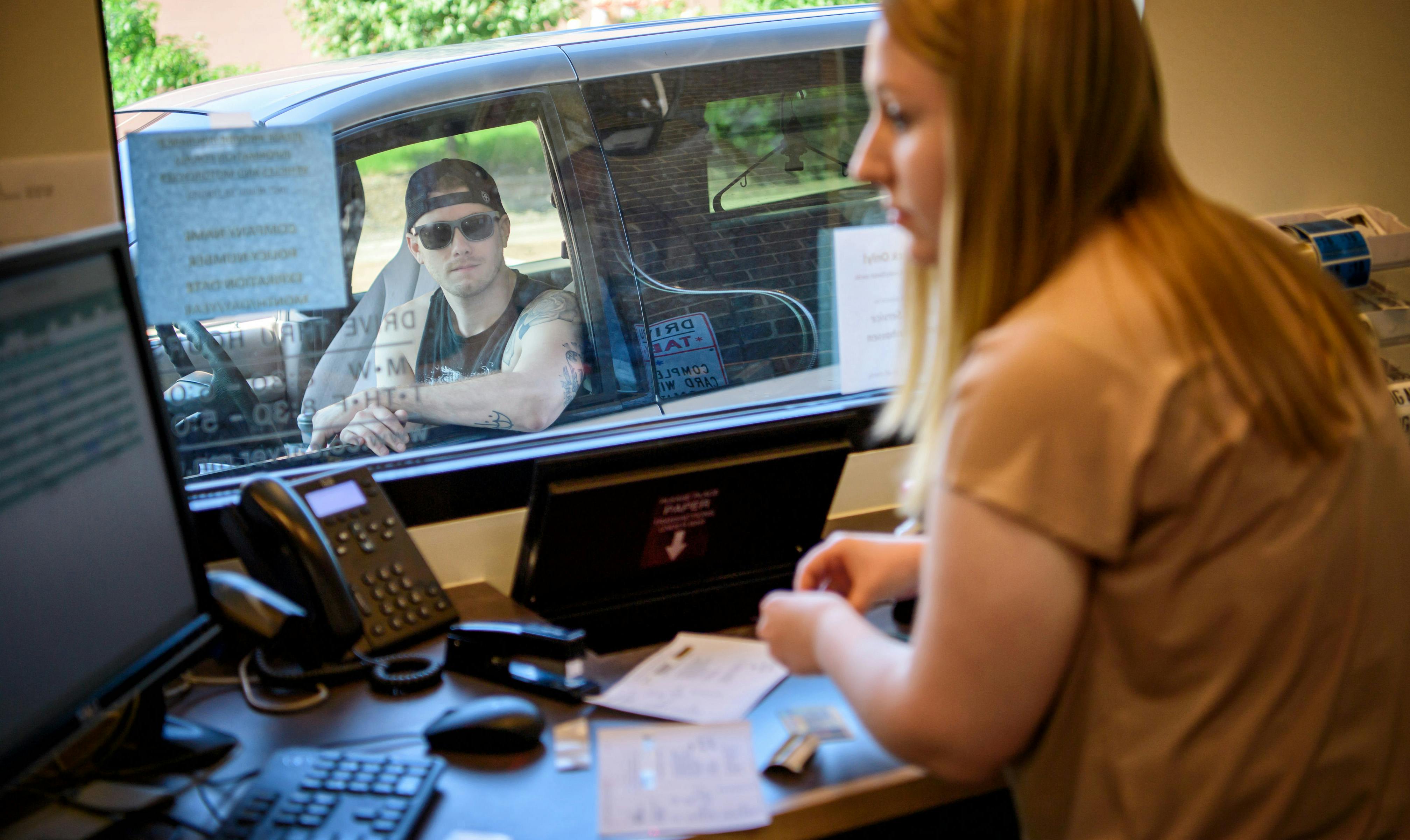 Miranda Sylvander helped Jacob Leverenz get a new set of vehicle license plates and tabs at the Carver County Service Center in Chanhassen in 2016.