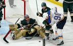 St. Louis Blues' Ryan O'Reilly (90) works against Minnesota Wild's Kevin Fiala (22) for the puck in front of Wild goalie Marc-Andre Fleury during the 