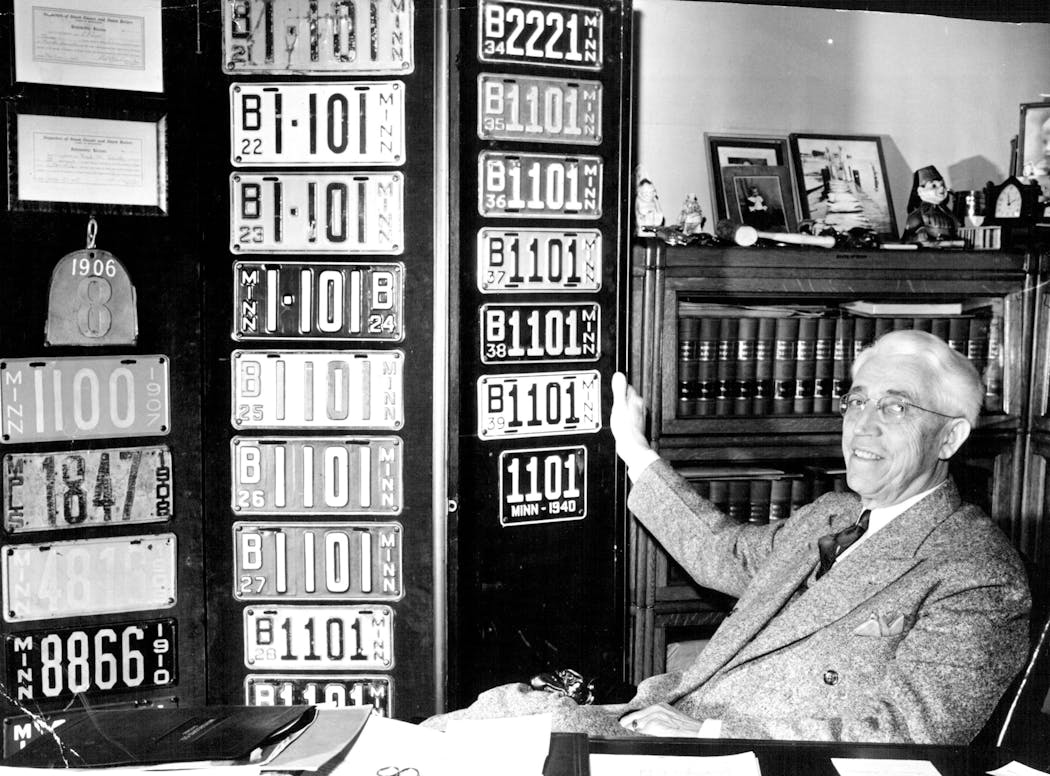 Minnesota Secretary of State Mike Holm posed with a collection of vintage Minnesota license plates in 1941.
