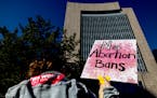 A demonstrator held up a sign at a rally Tuesday at U.S. Federal Courthouse Plaza in Minneapolis, following news of the leaked U.S. Supreme Court draf