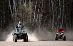Two ATV riders drove near the Nemadji State Forest in 2021. Much larger off-road vehicles would be permitted on state trails under a proposal to raise