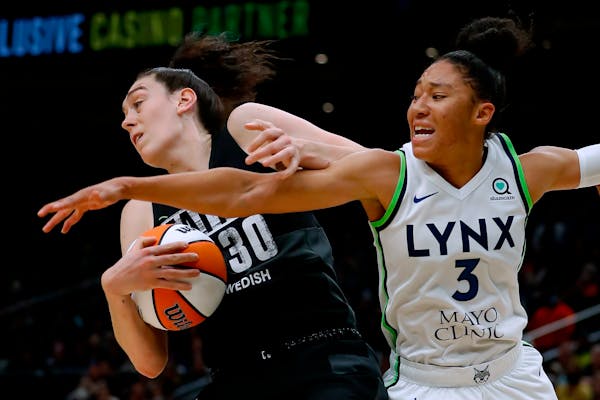 Seattle forward Breanna Stewart pulls a rebound away from Lynx guard Aerial Powers during the second quarter Friday.