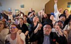 Lisa and Frank Vouk of St. Stephen, front, cheer during the final seconds of the Kentucky Derby on Saturday at the White Horse in St. Cloud.