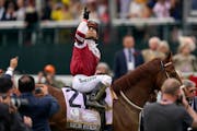 Sonny Leon, riding Rich Strike, celebrates after winning the 148th running of the Kentucky Derby 