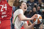 The Lynx’s Jessica Shepard tried to look for her shot against Washington’s Erica McCall in Minnesota’s 78-66 loss in the team’s WNBA home open