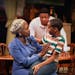 Tonia Jackson as Lena Younger and Joshaviah Kawala as Travis (with James T. Alfred as Walter Lee in the background) in the Guthrie Theater’s “A Ra