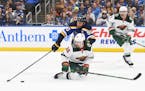 Mats Zuccarello of the Wild and Blues captain Ryan O’Reilly went after the puck during Sunday’s Game 4 in St. Louis.
