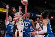 Fever forward Emily Engstler shot against Lynx forward Jessica Shepard (10) and center Sylvia Fowles (34) during Tuesday’s game.