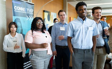 Aon apprentices including Kai Westby (third from left) listened to opening remarks during the Minnesota Apprentice Network professional mixer this mon