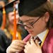 Elliott Tanner, 13, adjusted his tie while standing among his fellow physics graduates in a holding area before his graduation.