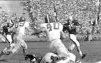 Gino Cappelletti (15) looked to elude the Nebraska defense during the Gophers’ 19-7 victory over the Cornhuskers in the 1954 season opener at Memori