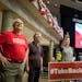 Paul Gazelka staffer Angel Zierden instructed volunteers where to hang the candidates signs and banners Thursday in Rochester as the stage was being p