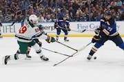 The Wild’s Frederick Gaudreau (89) shot the puck against the Blues’ Justin Faulk (72) during the first period.