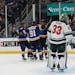 St. Louis Blues players celebrate after a goal against Wild goalie Cam Talbot during the second period in Game 6