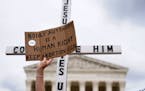 Demonstrators protest outside of the U.S. Supreme Court, Thursday, May 5, 2022, in Washington. A draft opinion suggests the U.S. Supreme Court could b
