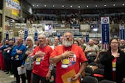 Delegates recite the Pledge of Allegiance at the start of the convention.