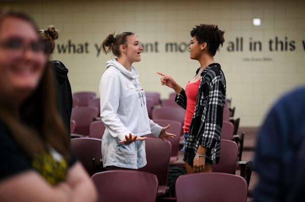 Ninth-graders Macy Sirek, left, and Haylie Starr run through things to say to discourage people actively using hateful language during an “Upstander