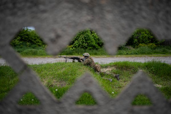 A Ukranian National Guard soldier guards a position during a reconnaissance mission in a recently retaken village in the outskirts of Kharkiv, east Uk
