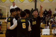 Co-captain Moua Tia Xiong, gesturing to crowd, helped form the boys’ volleyball team at Como Park Senior High School in St. Paul.