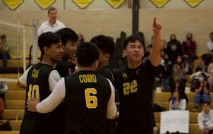 Co-captain Moua Tia Xiong, gesturing to crowd, helped form the boys’ volleyball team at Como Park Senior High School in St. Paul.
