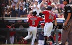 Luis Arraez (2) was welcomed back to the dugout by Gary Sanchez after Arraez scored on a single by Max Kepler in the first inning of the Twins’ 3-1 