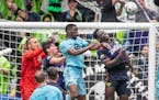 Seattle goalkeeper Stefan Frei, left, had help from two defenders in thwarting a Loons attack in the second half of the Sounders’ 3-1 victory over M