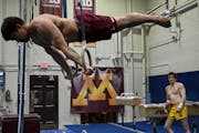 The Gophers’ Yaroslav Owens-Pochinka (shown practicing at Cooke Hall in April) won the GymACT national title on still rings with a score of 13.800 o