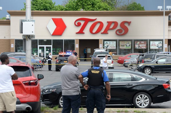 Police on the scene at a Tops Friendly Market Saturday in Buffalo, New York, after 10 people were killed in a mass shooting at the store.