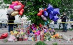 A makeshift memorial honors the victims of Saturday’s mass shooting at Tops supermarket in Buffalo, N.Y. The man accused of killing 10 in the racist